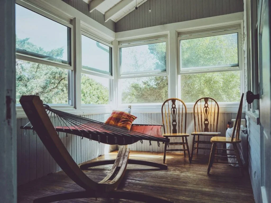 Wooden living room with oak chairs and an indoor hammock