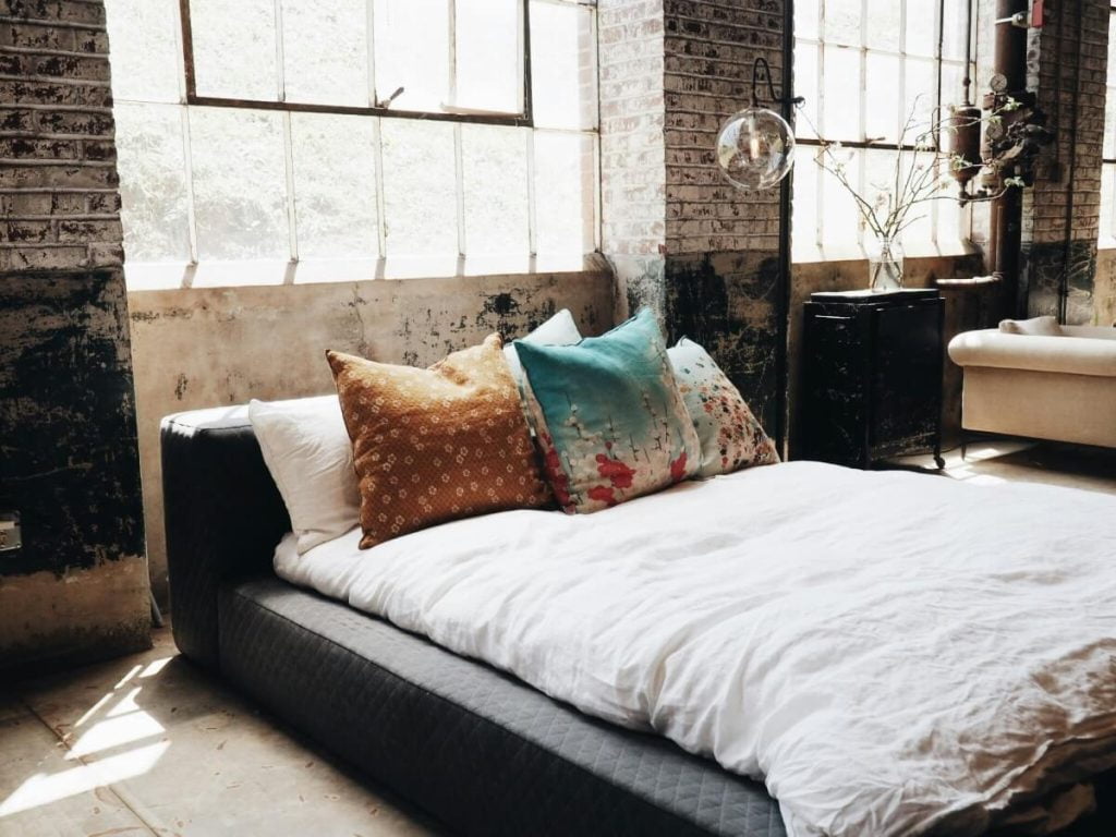 A Flat Organic Bed in a Brick Bedroom