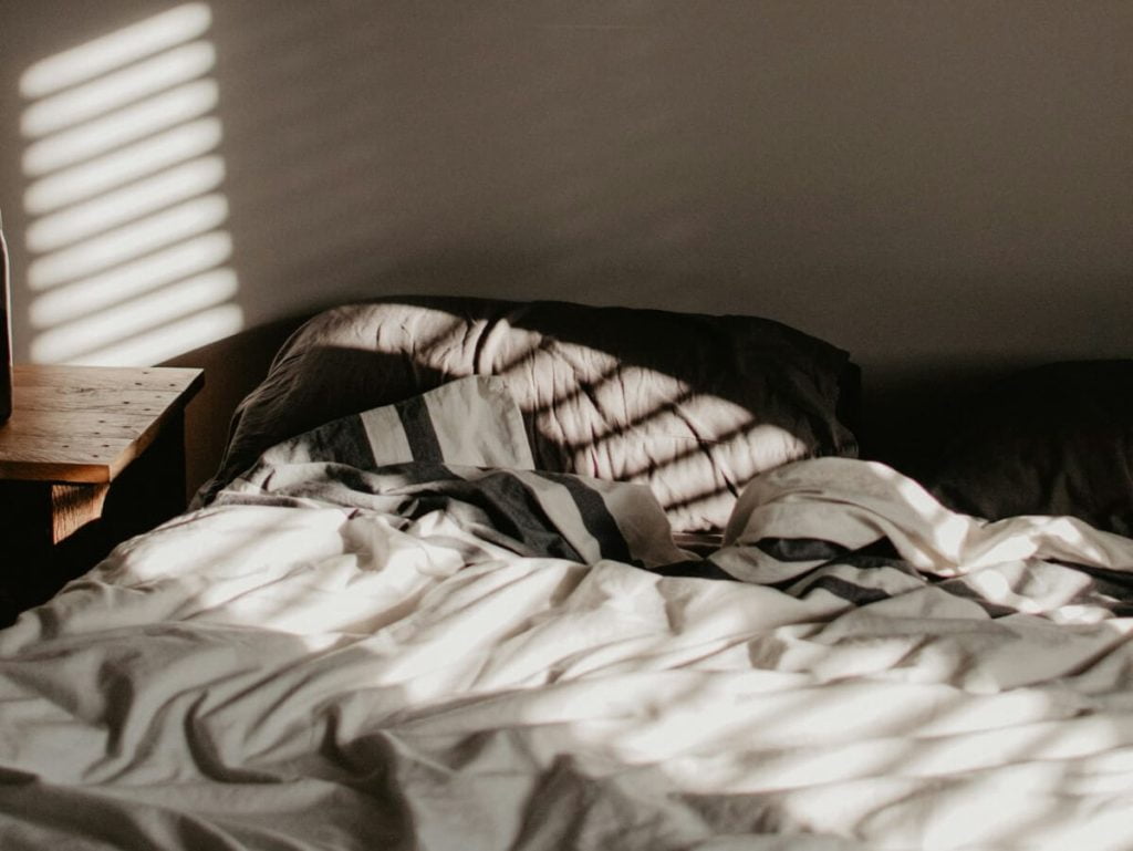Unorganized Cotton Bedding with Natural Light