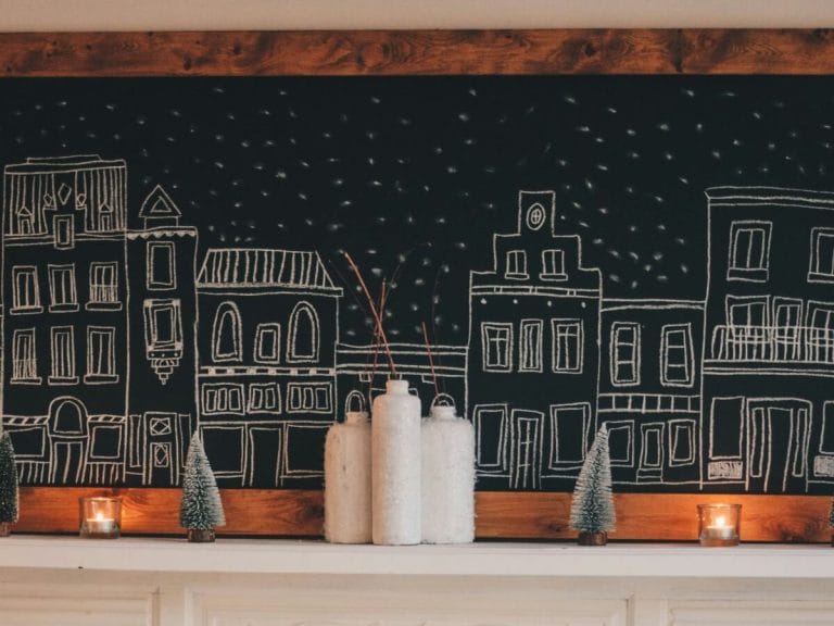 Cozy Christmas mantel with a chalkboard mural of a snowy village