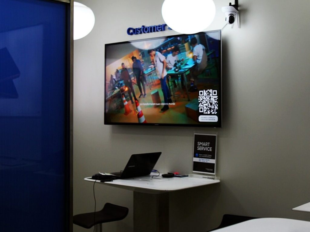 Bedroom TV mounted above desk for dual-purpose workspace and relaxation zone