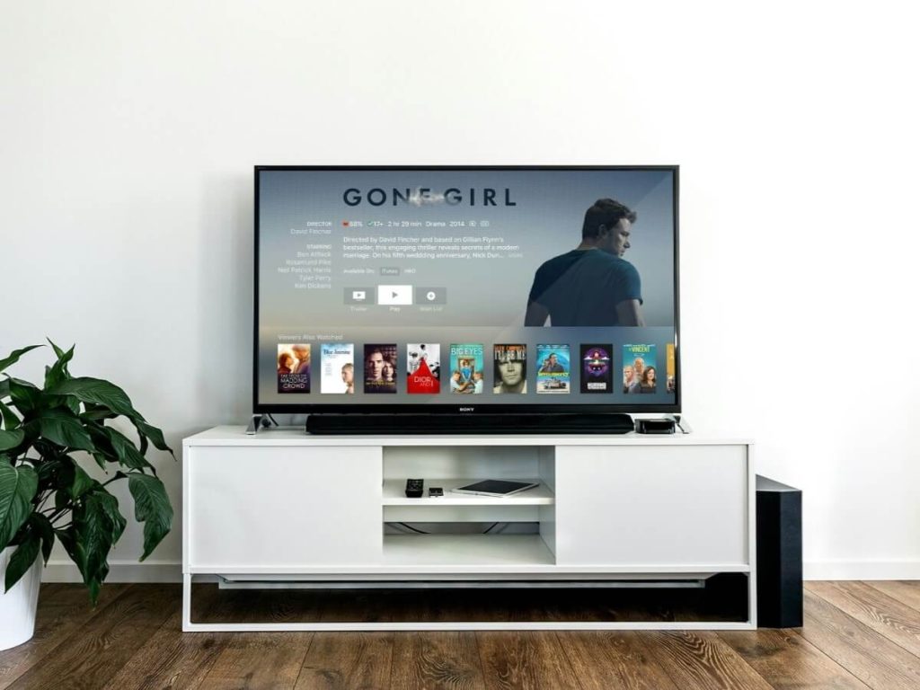 Contemporary living room shows how TV size complements room decor style, blending technology with aesthetic balance