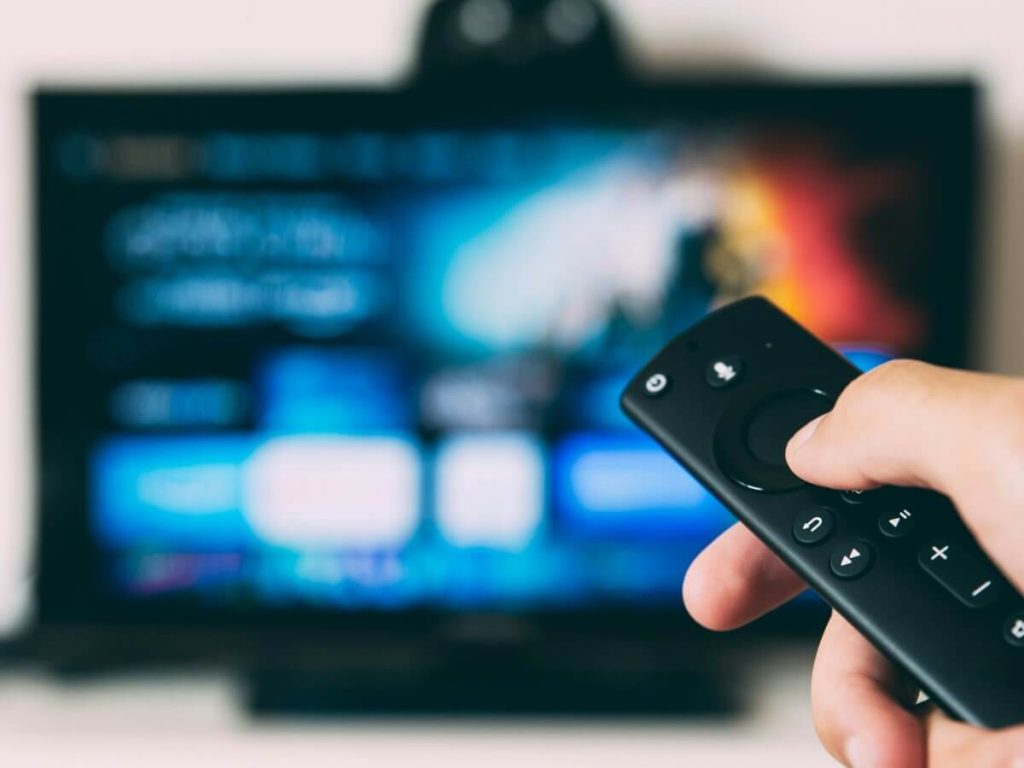 Corner-mounted TV on an articulating swivel arm makes use of awkward angles