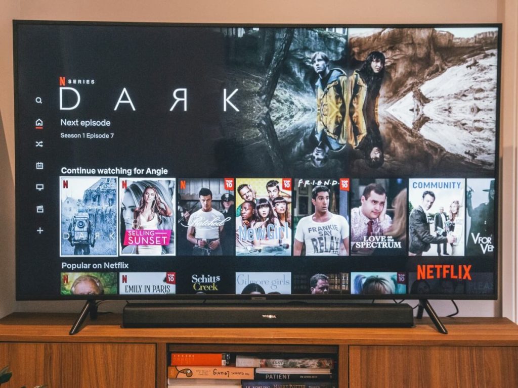 Modern TV on sleek stand demonstrates how to match TV size with TV stand width for safe and stylish small room decor