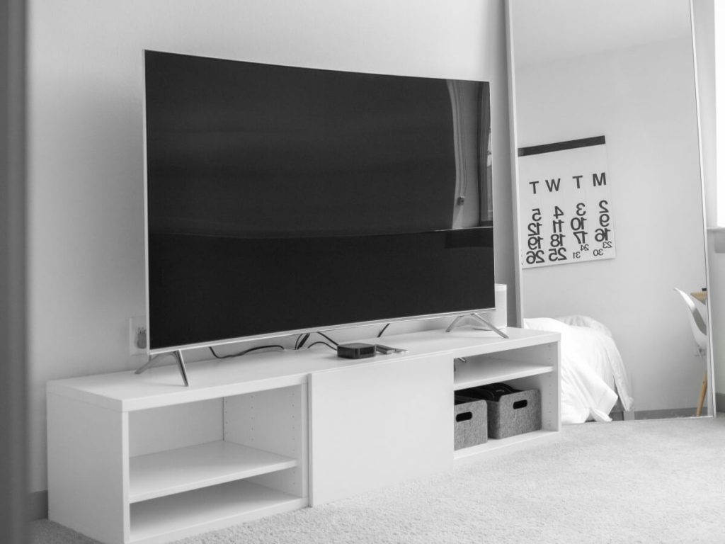 Modern TV in a small bedroom setup with smart TV placement