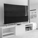 Modern small bedroom setup with smart TV placement and minimalist decor