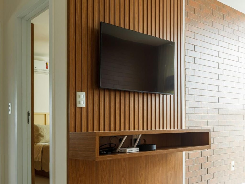 Wall-mounted TV positioned at perfect height illustrates proper TV size versus mounting height for ergonomic viewing