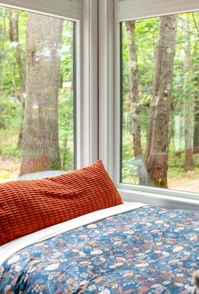 A cabin bedroom with nature view by Andrea Davis