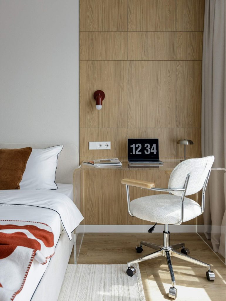A cozy bedroom apartment with home office setup and wooden backdrop by Aleksandra Dementeva